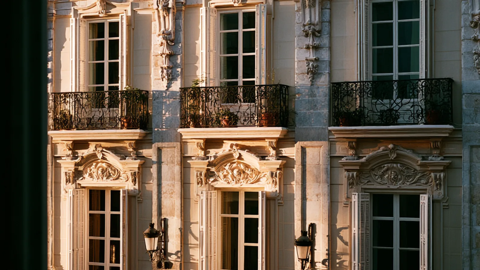 Classic Spanish facade with wrought-iron balconies in golden evening light