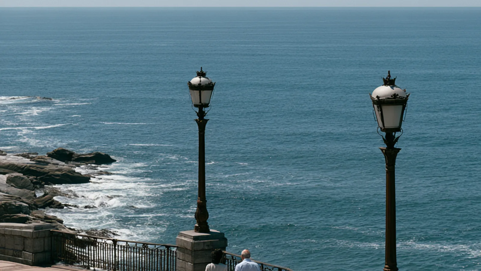 Seaside promenade with old lampposts above the Atlantic