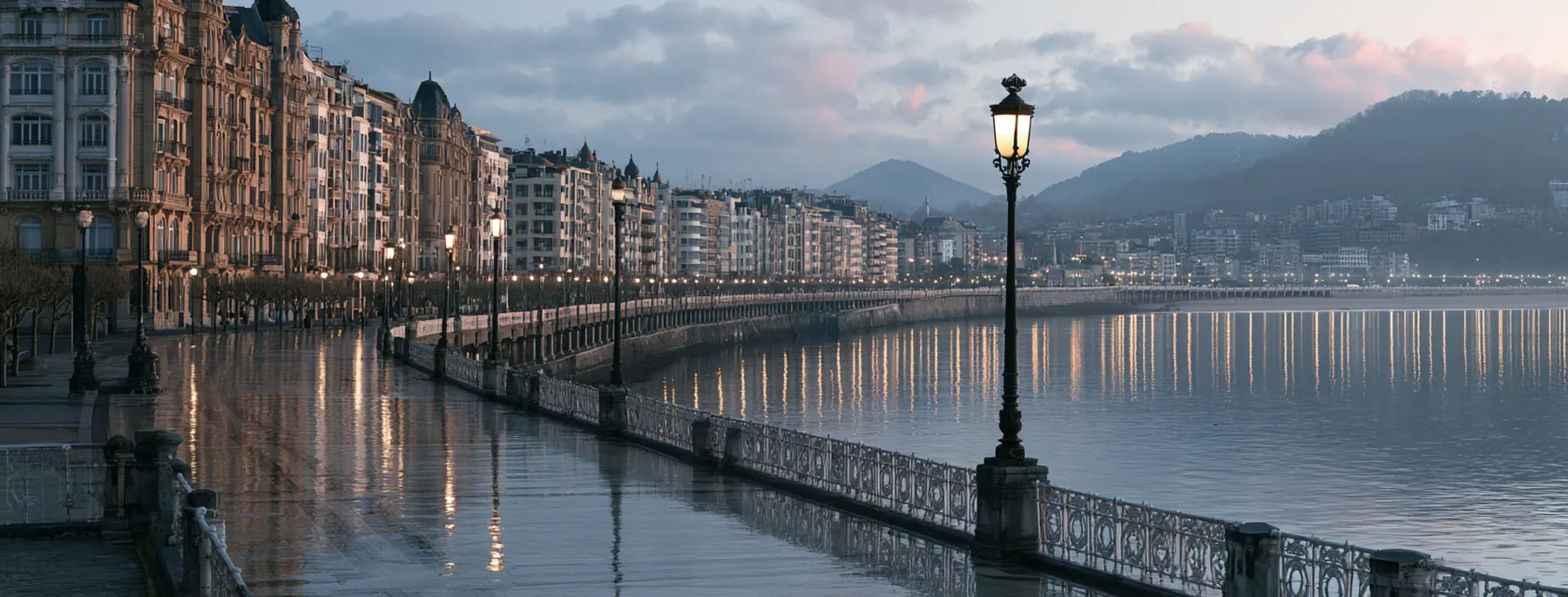 San Sebastián — rainy seaside promenade at dusk